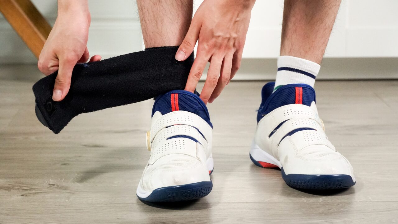 An ankle brace being applied.